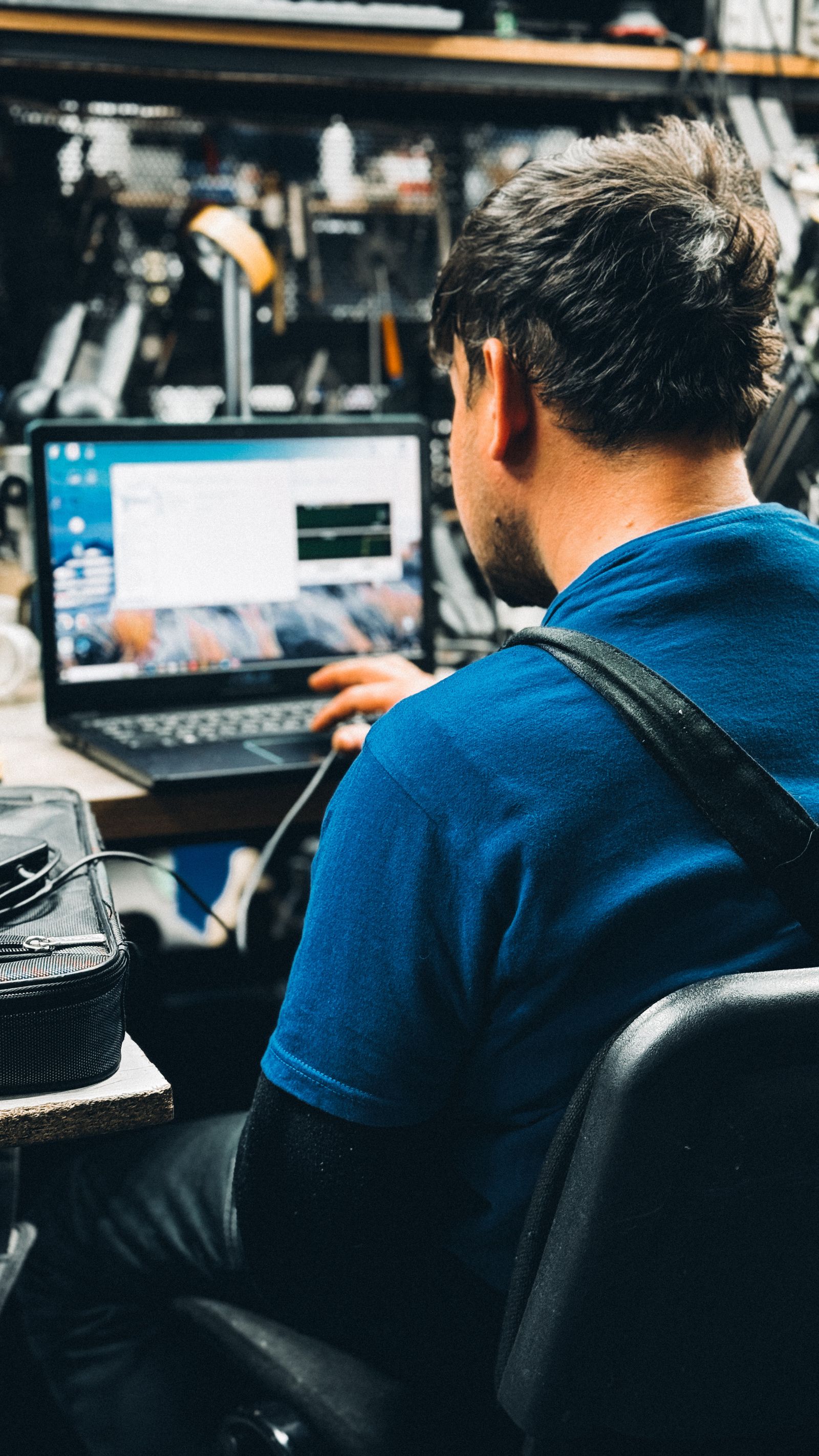 Catalog data work on a laptop in a workshop.