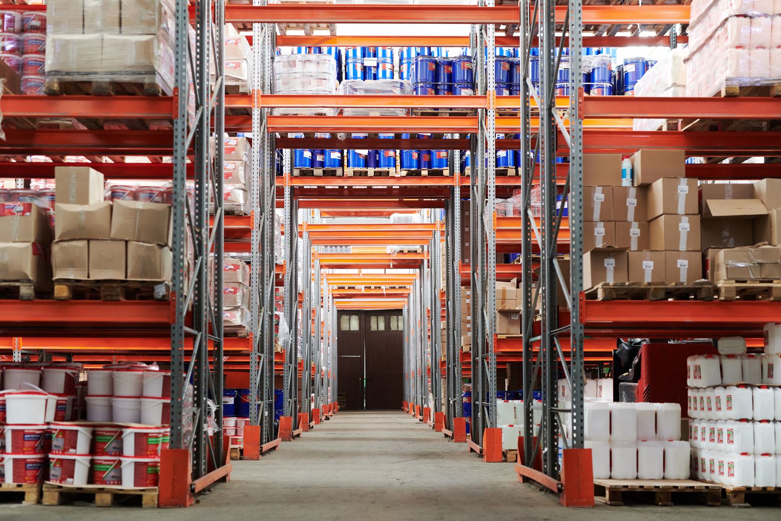 Organized warehouse aisle with pallet racking and inventory.
